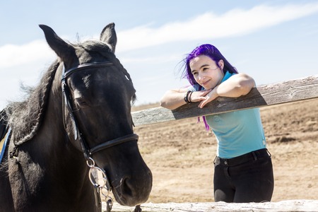 A Beautiful teen girl on the farm with her horse.の写真素材