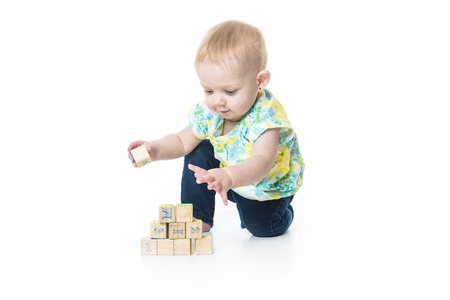A Happy kid playing toy blocks  isolated on white background