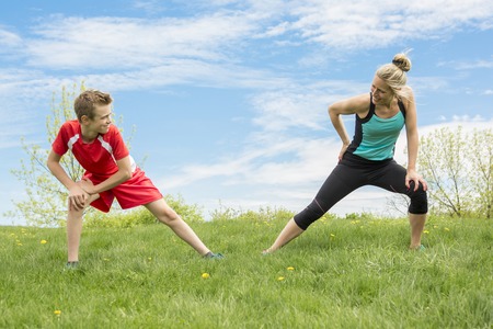 A Family, mother and son are running or jogging for sport outdoorsの写真素材