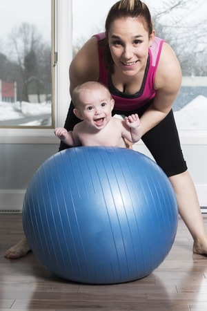 A Mother with child boy doing fitness exercises