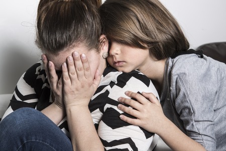 A sad mother consoling by his childの写真素材