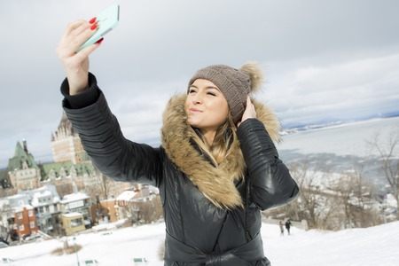 A glamorous winter portrait of a girl outsideの写真素材