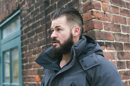 A Gorgeous young man looking outdoors in winter seasonの写真素材