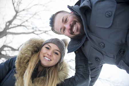 Two friends having fun in winter seasonの写真素材