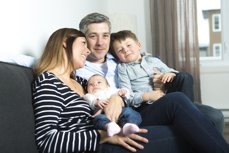 A happy family mother, father and two children at home