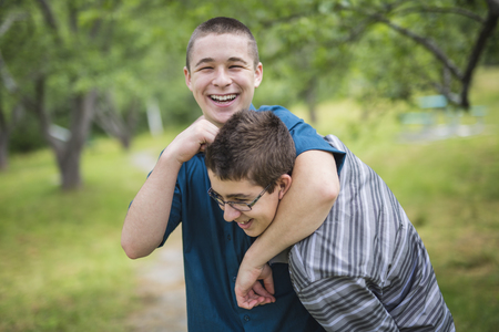 Two brothers having fun outside in forestの写真素材