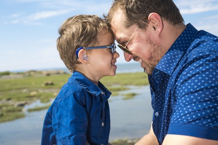 A Father And Son Hugging On Outdoor summer