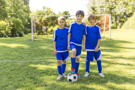 three, Young boy with soccer ball on a sport uniformの写真素材
