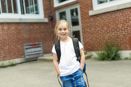 eight years old school girl close to the schoolyardsの写真素材