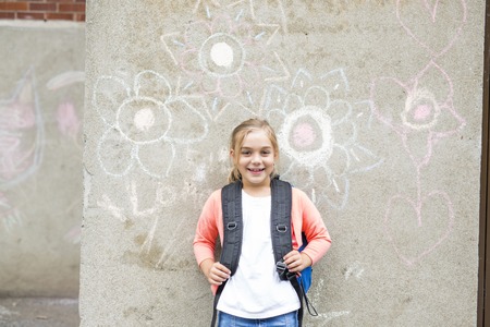 A eight years old school girl close to the schoolyardsの写真素材
