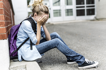 Unhappy Pre teen girl at schoolの写真素材