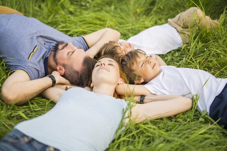 An Happy family having taking good time in the meadowの写真素材