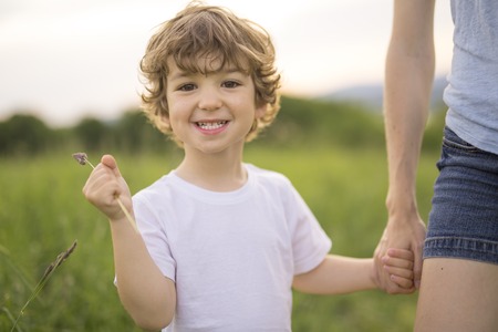 A mother and son holding hand in handの写真素材