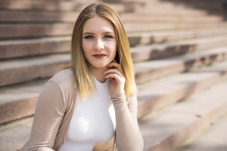 A woman Relaxing Outside. waiting on the stairの写真素材