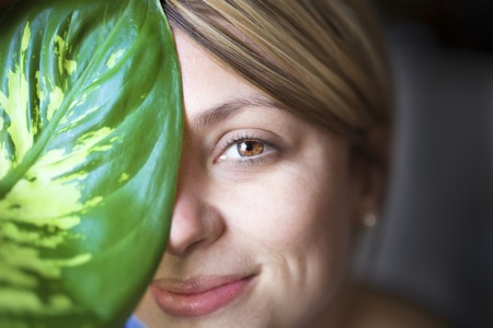 Skin care woman face with green leafの写真素材