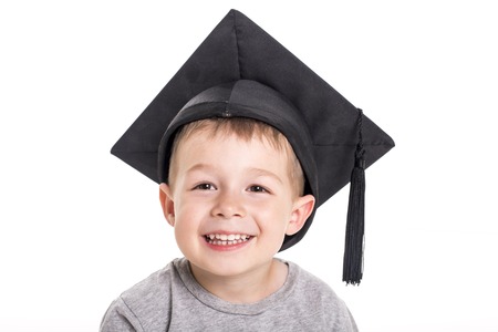 Adorable four years old child boy wearing a mortar board.の写真素材