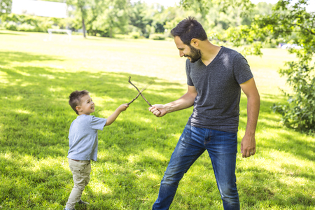 Father and son playing on the meadow.の写真素材