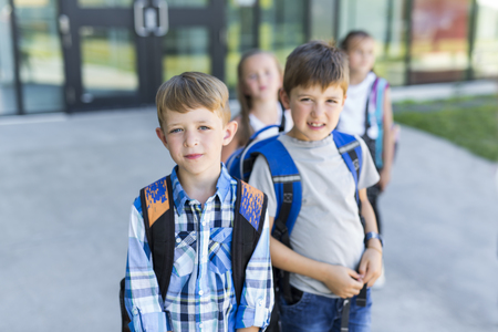 Portrait Of School Pupils Outside Classroom Carrying Bagsの写真素材