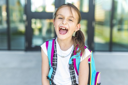Girl Standing Outside School With Bagの写真素材