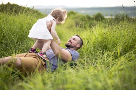 Beautiful portrait of young attractive father with daughter toddlerの写真素材