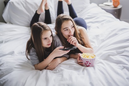 friendship, people, pajama party, entertainment and junk food conceptの写真素材