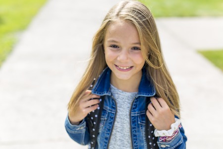 Great Portrait Of School Pupil Outside Classroom Carrying Bagsの写真素材