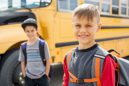 Great Portrait Of School Pupil Outside Classroom Carrying Bags