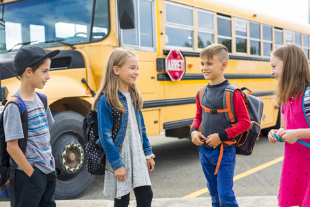 Great Portrait Of School Pupil Outside Classroom Carrying Bags