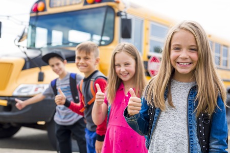 Great Portrait Of School Pupil Outside Classroom Carrying Bagsの写真素材