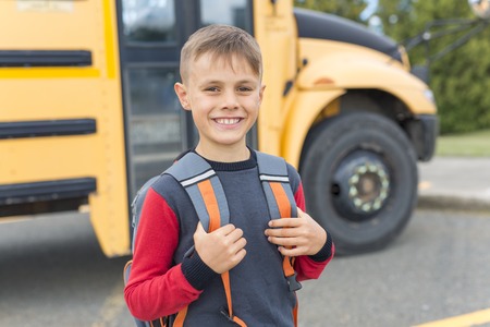 Great Portrait Of School Pupil Outside Classroom Carrying Bags