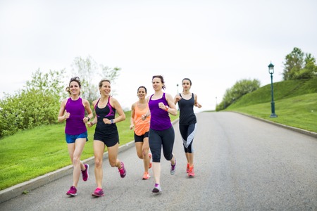group of people enjoying in the fitness having fun running outsideの写真素材