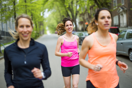 group of people enjoying in the fitness having fun running outsideの写真素材