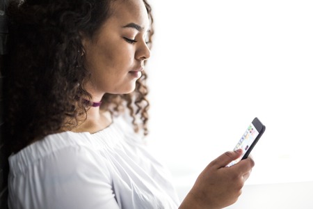 Handsome Afro American teen using a smart phone