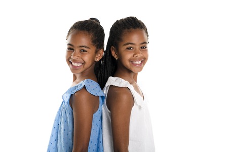 Two Adorable african twin girl on studio white backgroundの写真素材