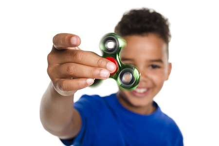 Boy Fidget Spinner Held in Foregroundの写真素材