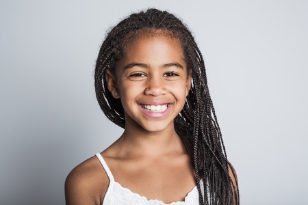 Adorable african little girl on studio gray background