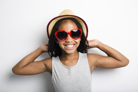 Adorable african little girl on studio gray background