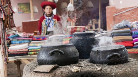 A Quechuan woman demsontrates alpaca wool weaving.の写真素材