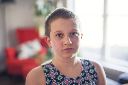 teen with shaved head st homeの写真素材