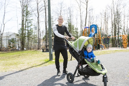 Father and son walking in the park. Family and sport concept.