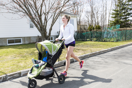 Mother doing Training, jogging with babyの写真素材