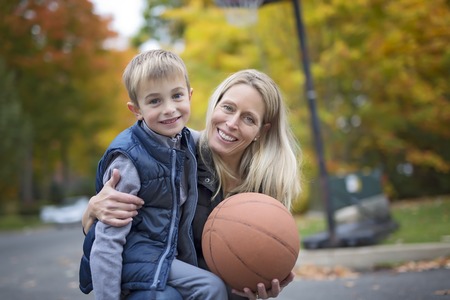 mother play basketball with his sonの写真素材