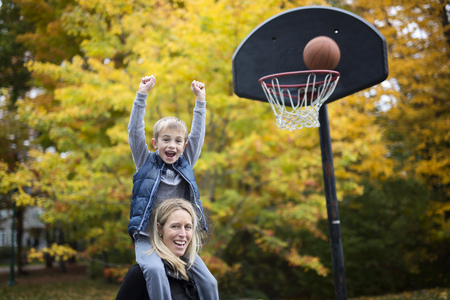 mother play basketball with his son