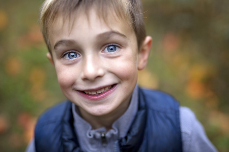 Portrait of a five year old boy in autumn seasonの写真素材