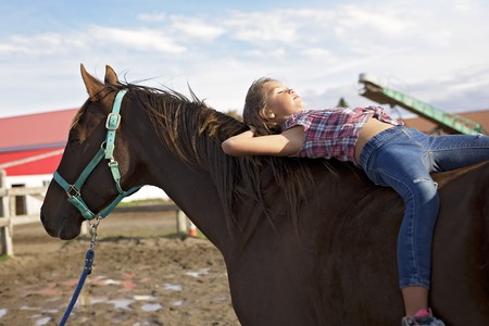 Autumn season young girl and horseの写真素材