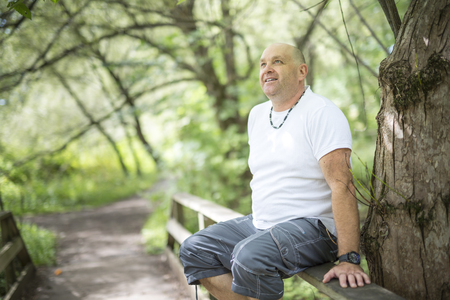 men outdoors close to 50s in forestの写真素材