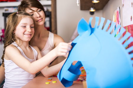 A Young Girl use his imagination with cardboardの写真素材