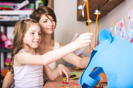 A Young Girl use his imagination with cardboardの写真素材