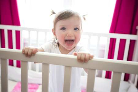 A Cute little girl in cradle at baby roomの写真素材