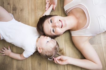 A Nice shot of child and mother spending time, lay at home